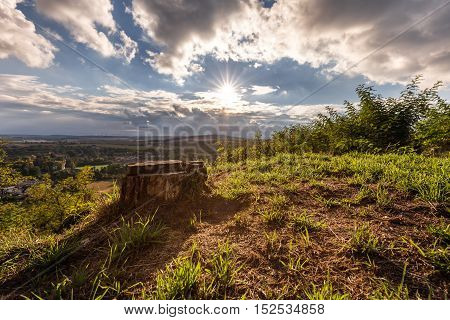 Hill bathed in sunshine and a tree stump. Moravian landscape Svitavka.
