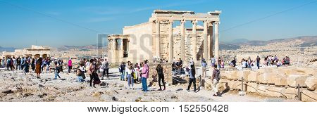 Athens, Greece - October 14, 2016: Panoramic view with tourists taking photo near Erechtheum temple ruins decorated with Caryatids female statues in Acropolis