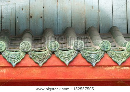 Texture of Chinese style old roof and blue wooden wall as background .