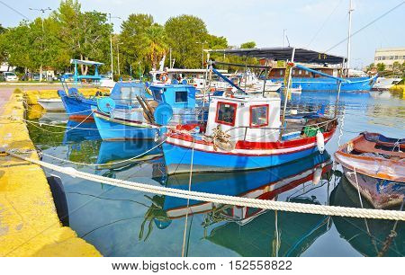 boats reflected on sea at Eleusis harbor Greece