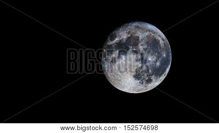 Moon against the black sky. Night. Darkness.