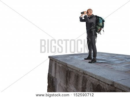 Businessman with backpack and binoculars watching from above