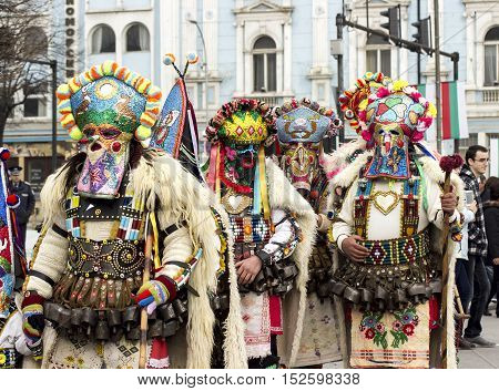 Varna Bulgaria - January 30 2016: Unidentified man in traditional Kukeri costume are seen at the Festival of the Masquerade Games Surva in Varna Bulgaria.