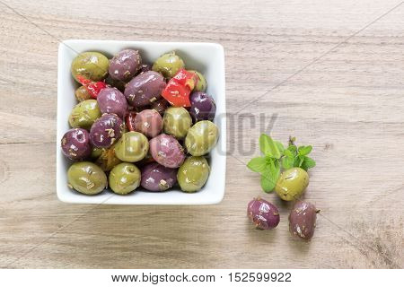 Portion of olives on a wooden table