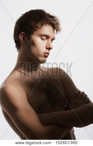 Nude young man closed his eyes dreamily