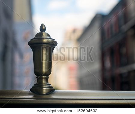 Finial on balcony near city building and urban area on clear day-background photo