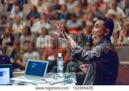Speaker giving a talk on scientific conference. Audience at the conference hall. Business and Entrepreneurship event.