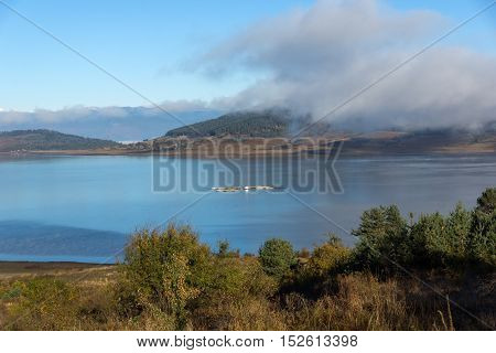 Landscape with Low clouds over water of Batak Reservoir, Pazardzhik Region, Bulgaria