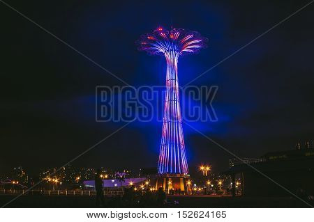 lit up coney island tower during a summer night