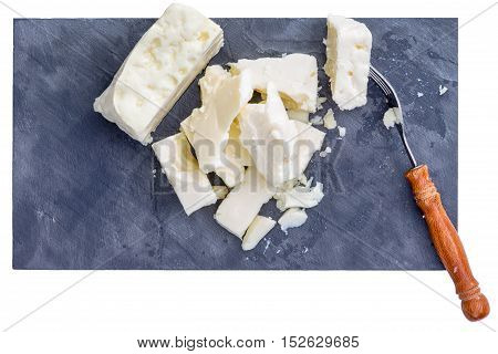 Top down close up view on fork and pieces of full fat white cows milk feta cheese from top down perspective
