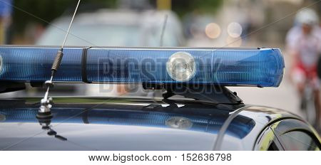 Blue Flashing Lights Of The Police Car At A Sports Event