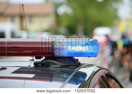 Blue Flashing Lights Of The Police Car At A Sports Event