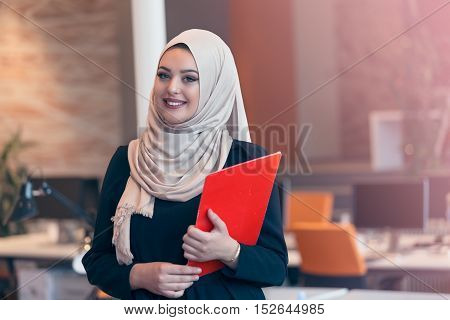 Arabian Business Woman Holding A Folder In Modern Startup Office