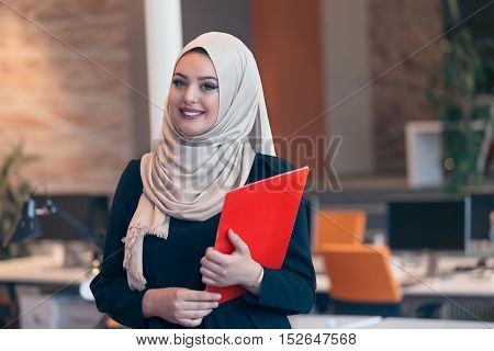 Arabian Business Woman Holding A Folder In Modern Startup Office