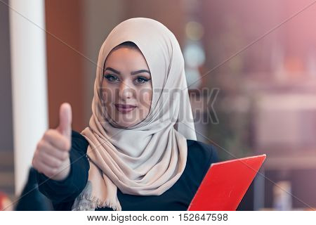 Arabian Business Woman Holding A Folder In Modern Startup Office