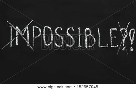Impossible written with white chalk on a blackboard