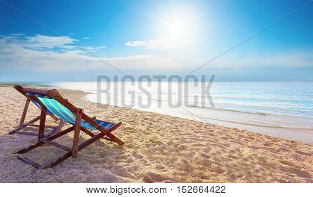 couples of wood chair beach and blue sky at sea side for summer vacation