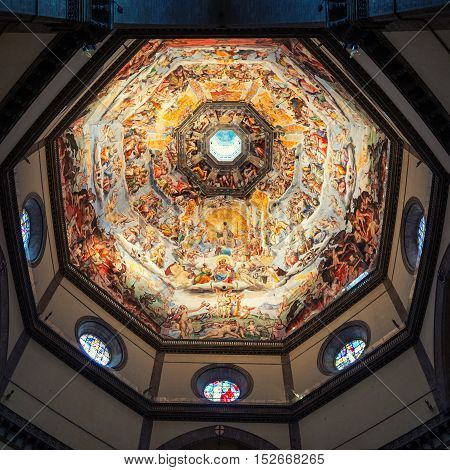 FLORENCE ITALY - MARCH 9 2016: Inside Cattedrale di Santa Maria del Fiore. Famous Vasari's fresco on the ceiling. Interiors of a popular religious landmark