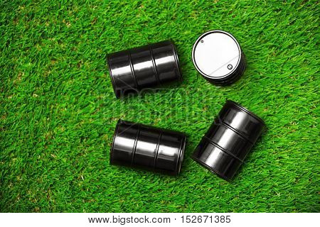 High angle view on four oil drums on a grass