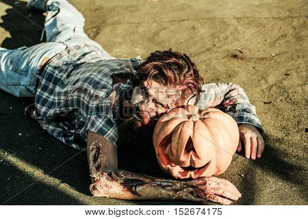 Zombie Man Lies On Pumkin