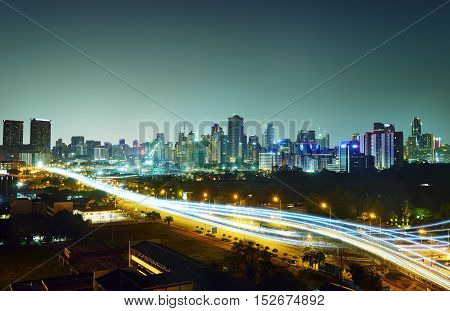 Abstract and car lighttrail background city skyline downtown background and highway interchanged nigh view .