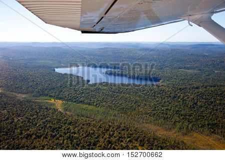 Adirondack forests, lakes, creeks and mountains aerial terrain view down from light aircraft