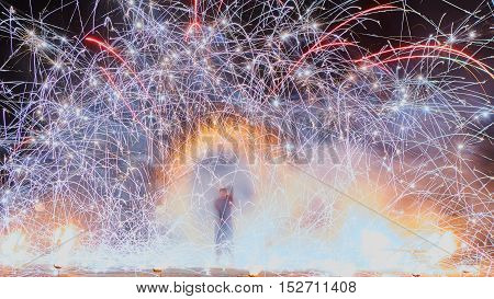 Artists juggling with burning poi's at fire performance. Long exposure causing painting with light.