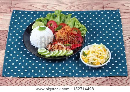 Jasmine rice with spicy fried chicken salad (Khao Yum Kai Zap in Thai) served mixed vegetables salad.