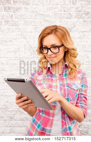 Pretty Blonde In Glasses Using Tablet To Seng Message