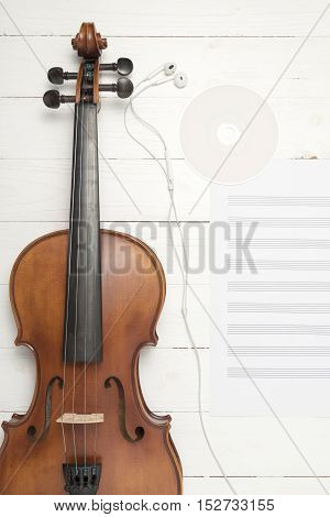 violin with music paper note and dvd disc on white wood background