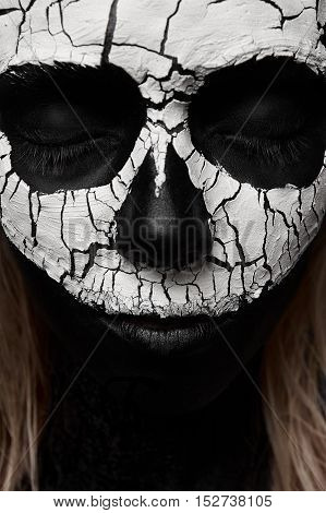 Beauty Woman with Skull on her Face. Halloween Makeup Concept