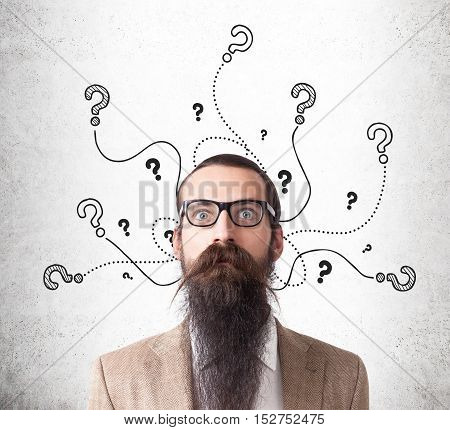 Baffled Man And Question Marks On Concrete Wall