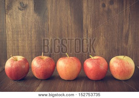 Apples on wooden rustic background. Autumn and harvest concept with copy space selective focus toned horizontal