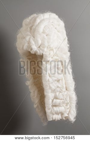 Judge wig white hair on a gray background