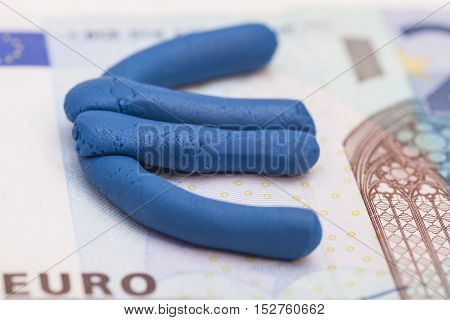 Plasticine euro icon on euro banknote background