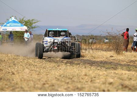 Speeding White Chenowth Rally Car Front View