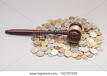 judges law gavel on pile of coins isolated on gray