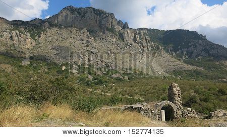 the ruins of ancient buildings on the background of mountains