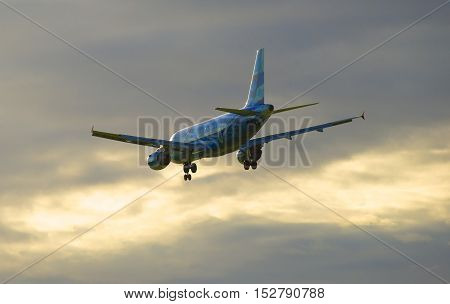SAINT PETERSBURG, RUSSIA - JULY 24, 2015: Flying on the sunset sky background Airbus A319-111 (VQ-BAS) of the airline 