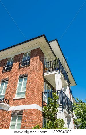 The corner of brand new apartment building on blue sky background in British Columbia Canada