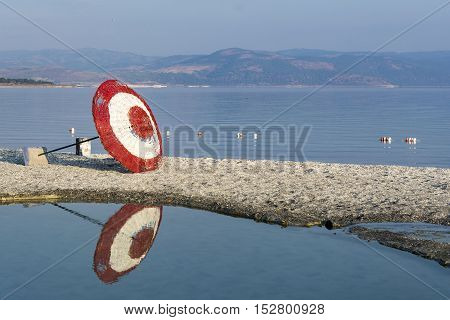 Laying beach umbrella at the lake. Wide angle image