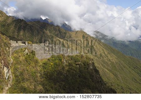 Ancient Inca ruin of Sayaqmarka watching over an andes valley