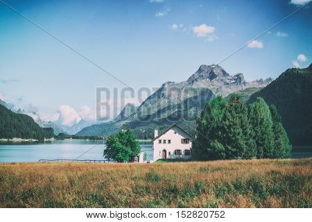 Amazing sunny day at Champferersee lake in the Swiss Alps. Silvaplana village, Switzerland, Europe, toned like Instagram filter