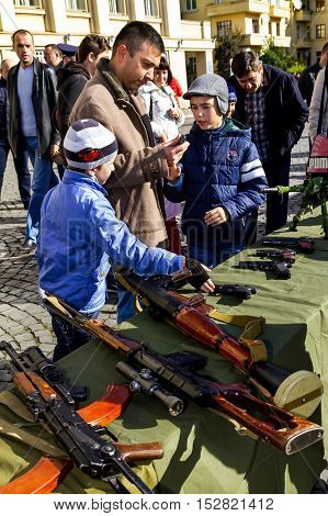 Uzhgorod Ukraine - 14 October 2016: Local residents consider the exhibition of small arms during the celebration of Defender of the Fatherland Day. This day Ukraine celebrates the Day of Defender of the Fatherland.