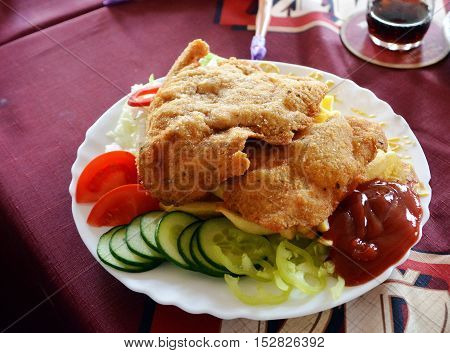 Closeup fried chicken and french fries on a plate