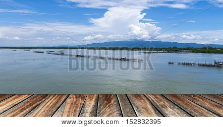 pier wood floor beside sea with blue sky background. summer relaxing time.