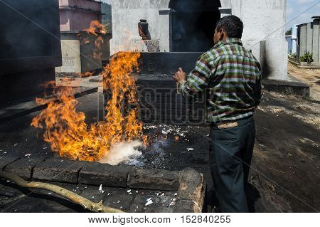 Chichicastenango Guatemala - April 26 2014: Maya man performing a ritual in the cemetery of the town of Chichicastenango in Guatemala