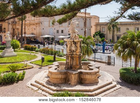 NOTO ITALY - SEPTEMBER 14 2015: Hercules fountain in Noto famed for its Baroque architecture. UNESCO World Heritage Site in Noto Sicily Italy.