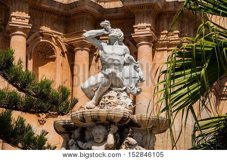 NOTO ITALY - SEPTEMBER 14 2015: Hercules fountain in Noto famed for its Baroque architecture. UNESCO World Heritage Site in Noto Sicily Italy.