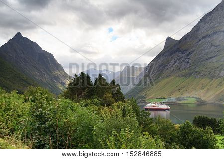 Ship at dramatic landscape, Hjorundfjord, Fjordland, Norway